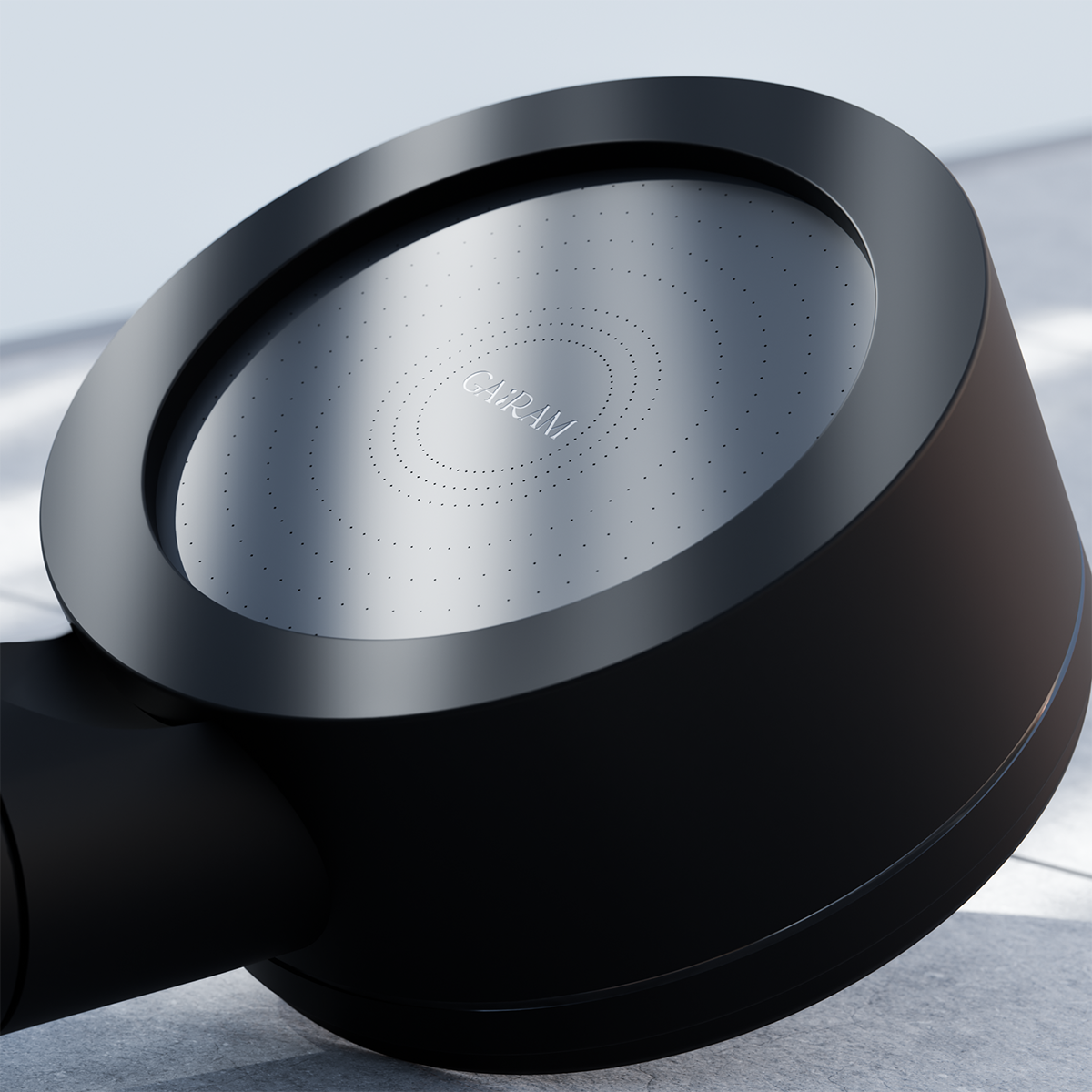 Close-up of the matte black shower head, focusing on the face of the product