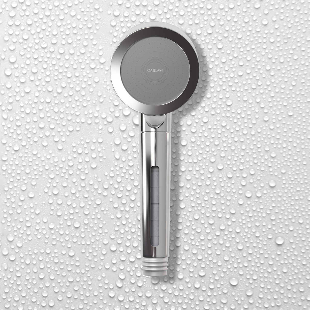 Front view of silver filtered shower head against a water drop-covered wall